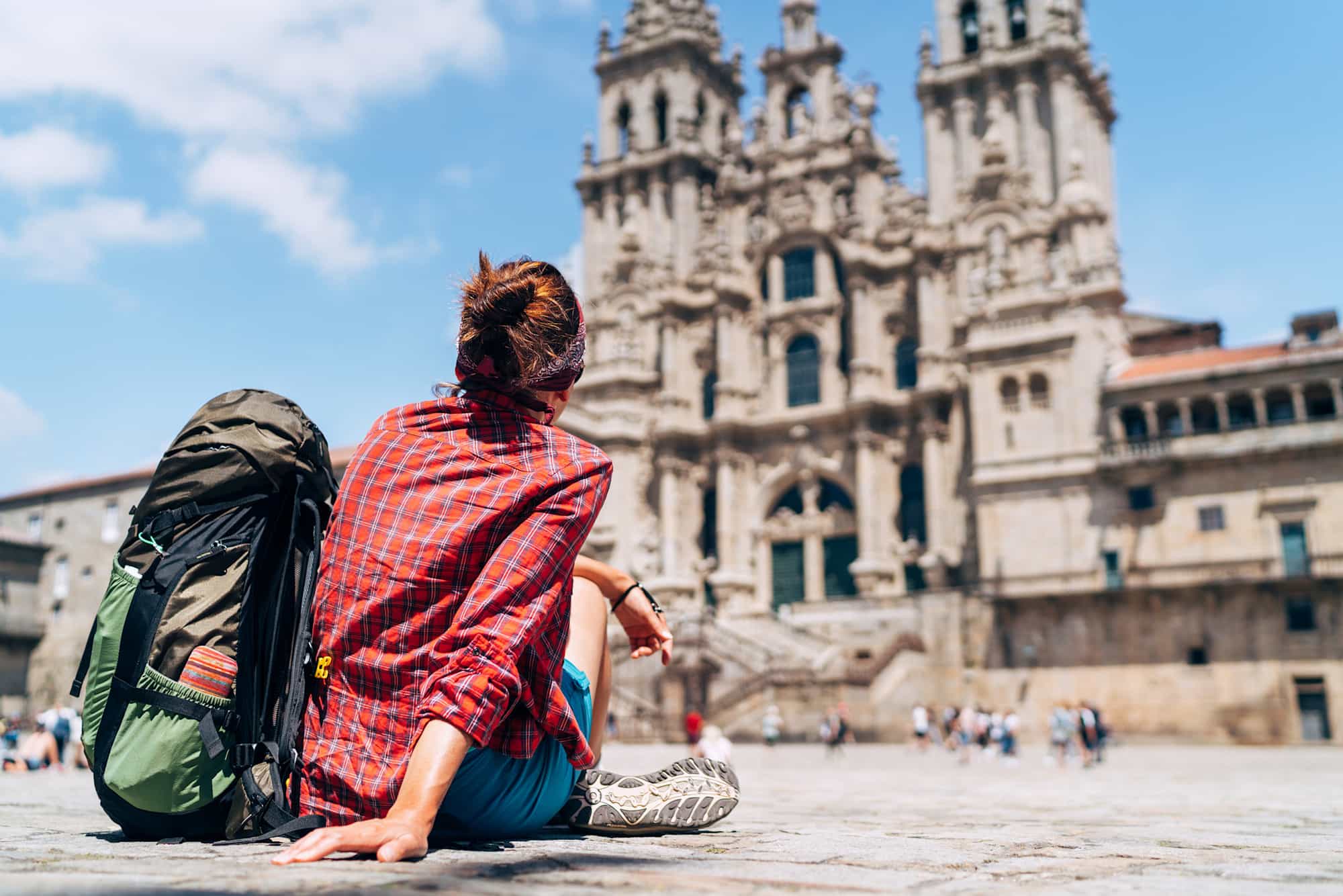 Hiker at the cathedral in Santiago de Compostela, Spain.