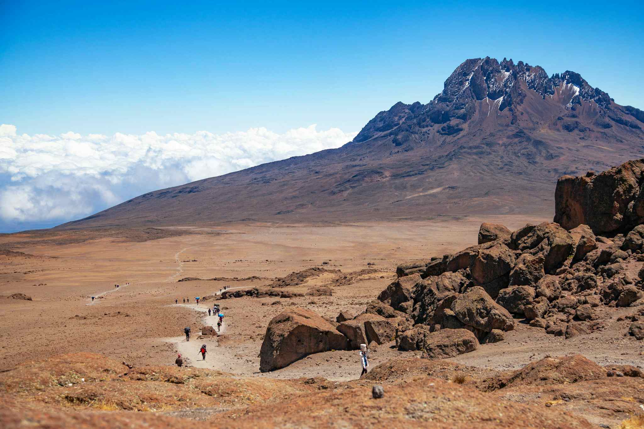 View of hikers approaching Mawenzi Peak along the Rongai Route, Mount Kilimanjaro, Tanzania.