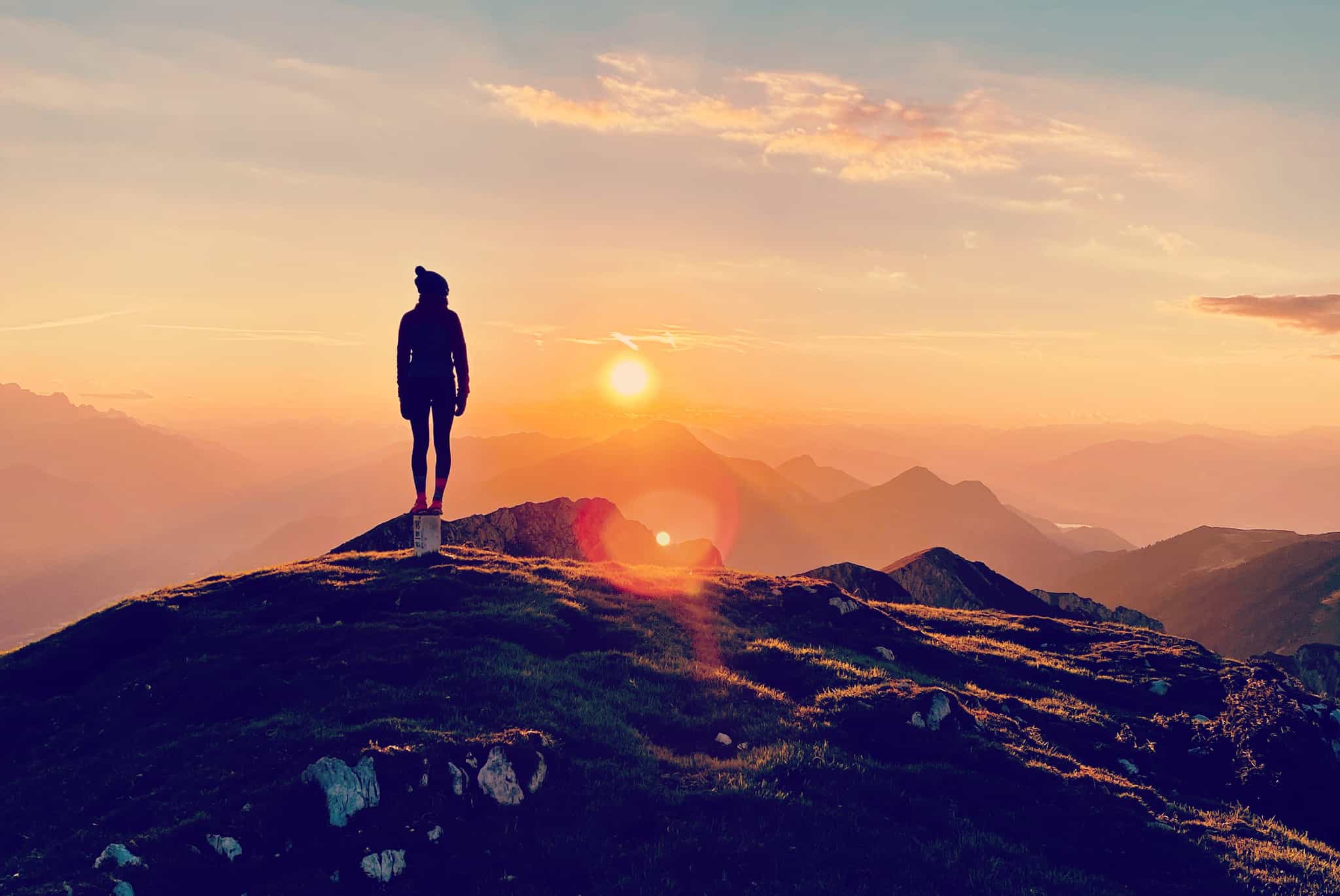 Hiker enjoys the sunset in the mountains