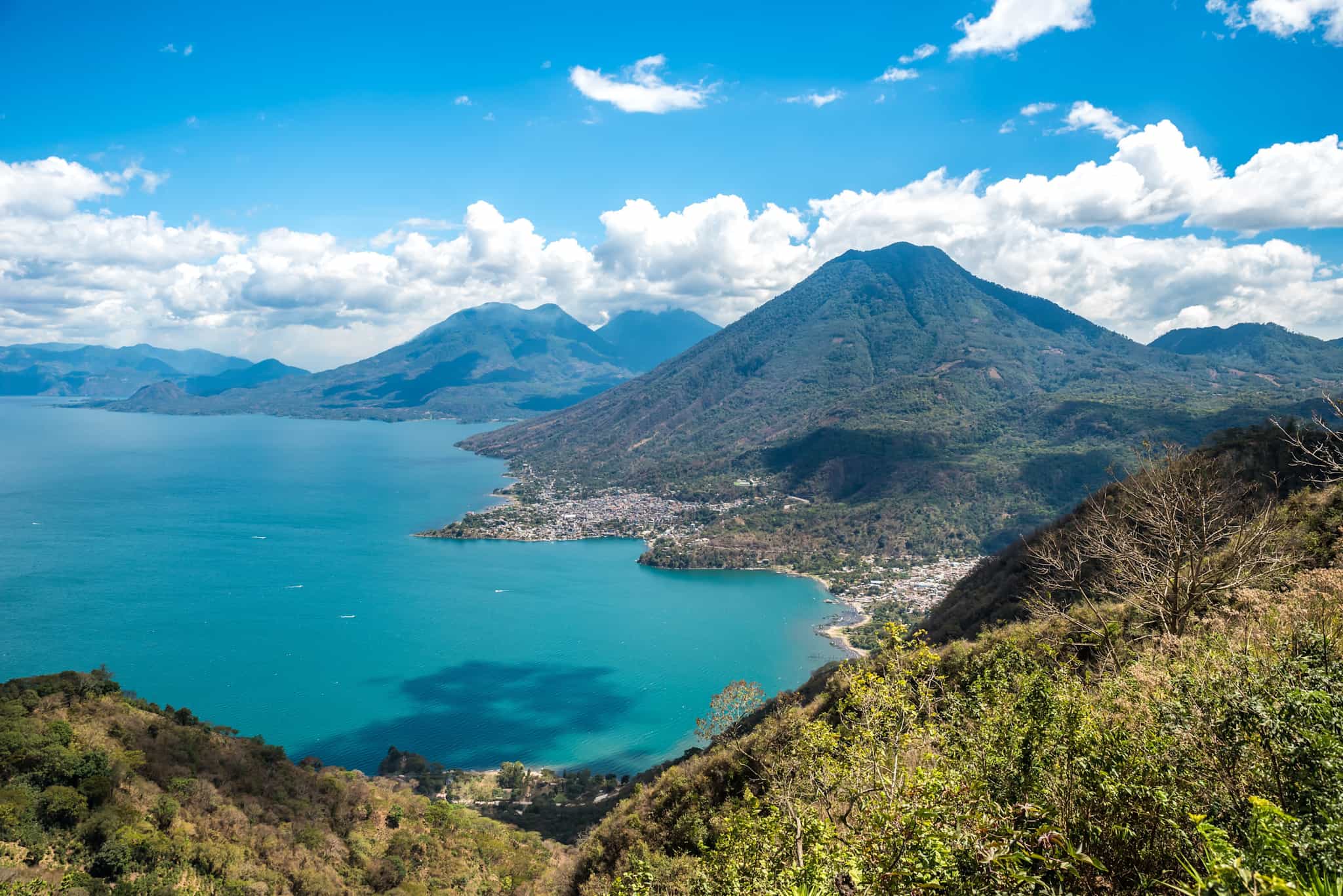 Viewpoint at lake Atitlan with the three volcanos San Pedro, Atitlan and Toliman - you can see the small villages San Pedro and San Juan at the lake in the highlands of Guatemala