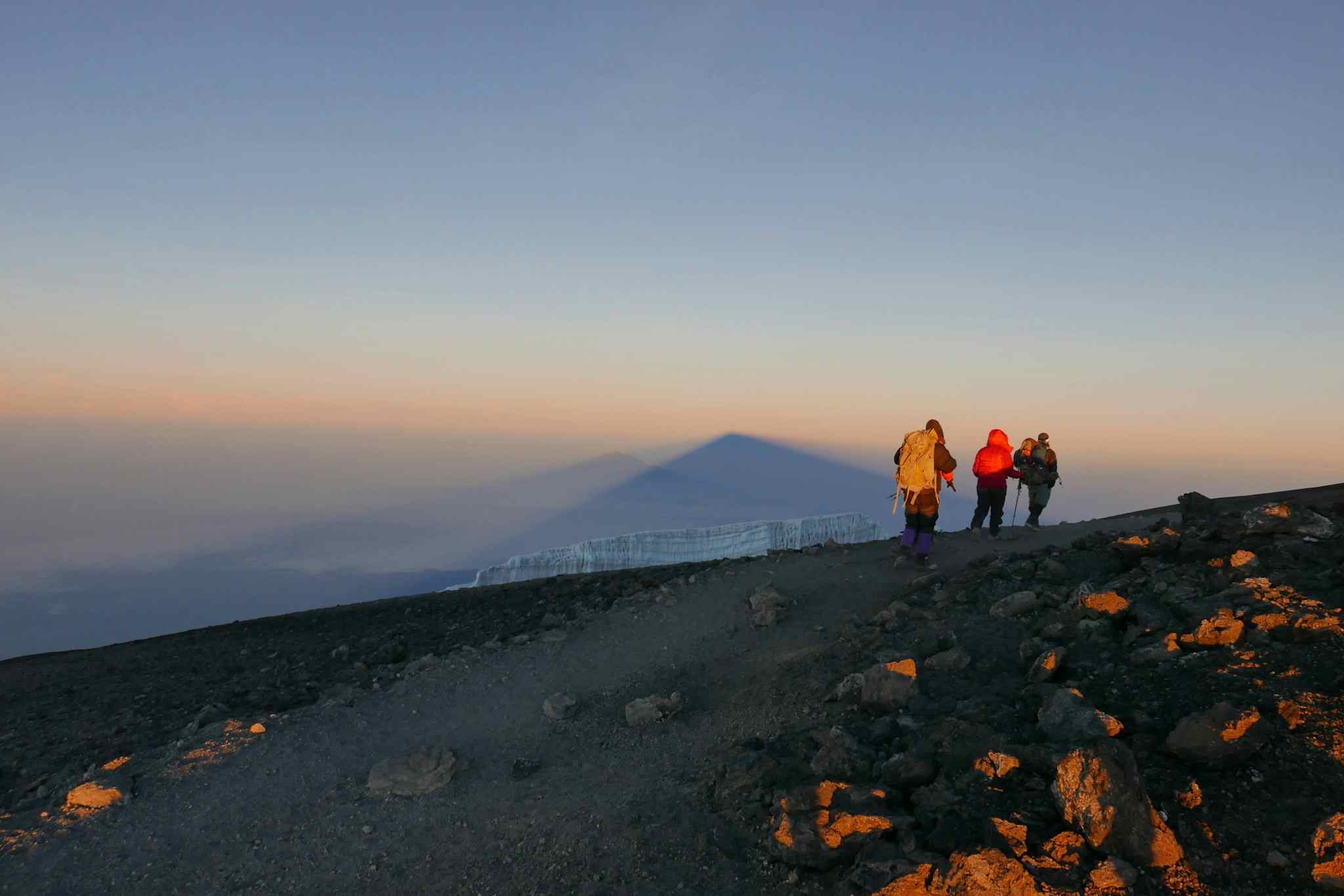 Hikers on their way to the summit of Mount Kilimanjaro at sunrise in Tanzania.