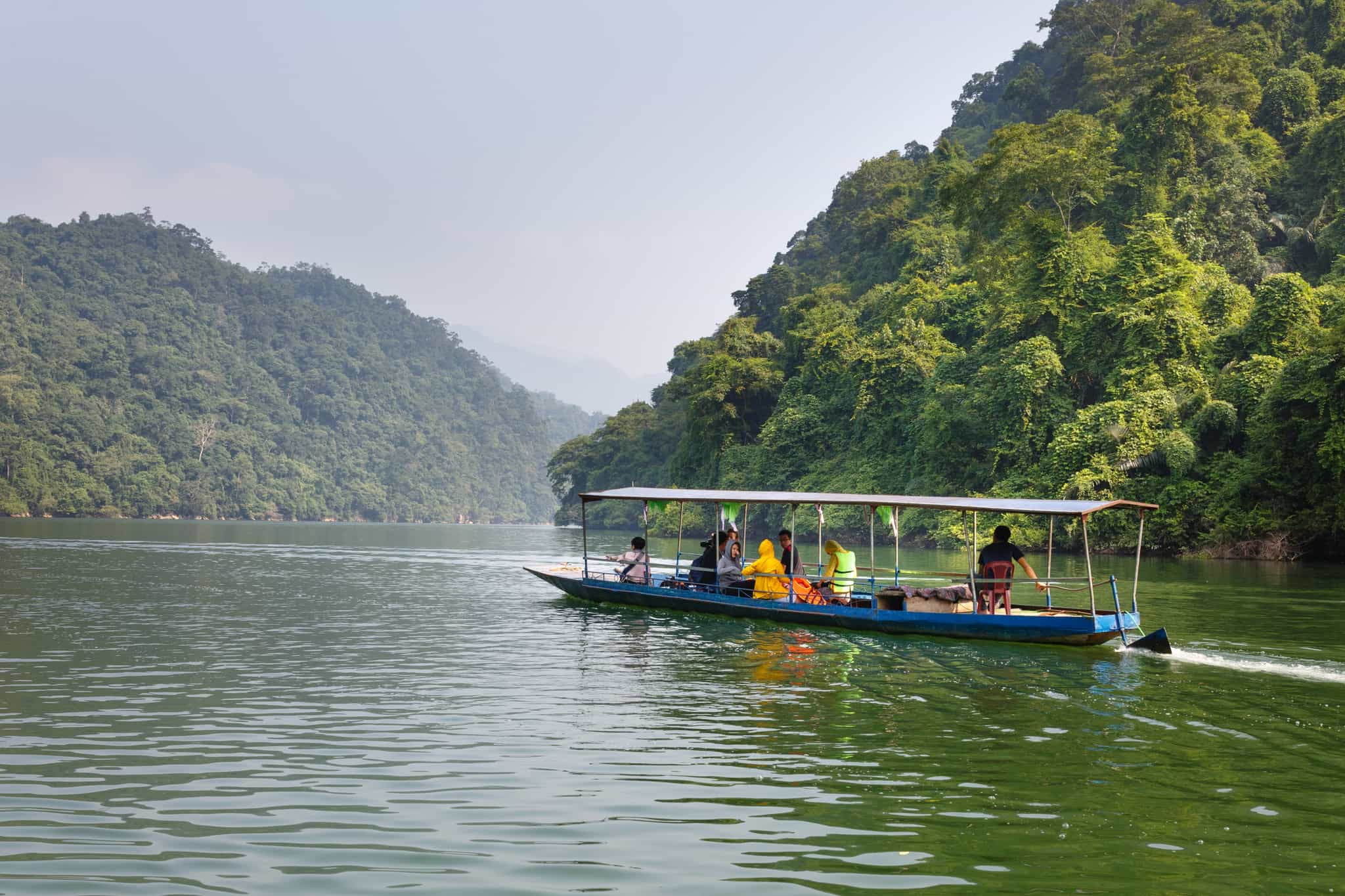 Shutterstock - Adventurers on a boat cruise across Ba Be Lake in Vietnam. Photo: Shutterstock #518398075