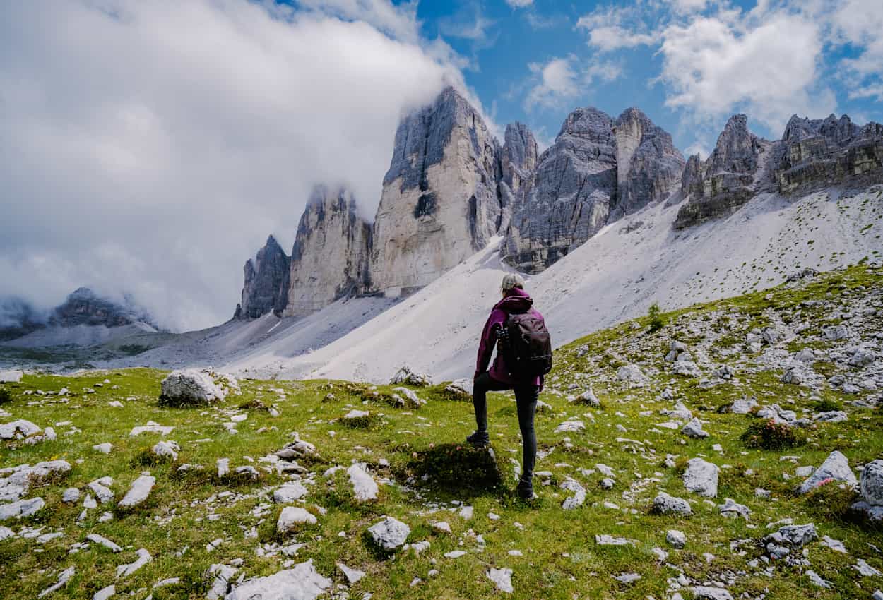 Hiker in front of the Tre Cime, Dolomites.
