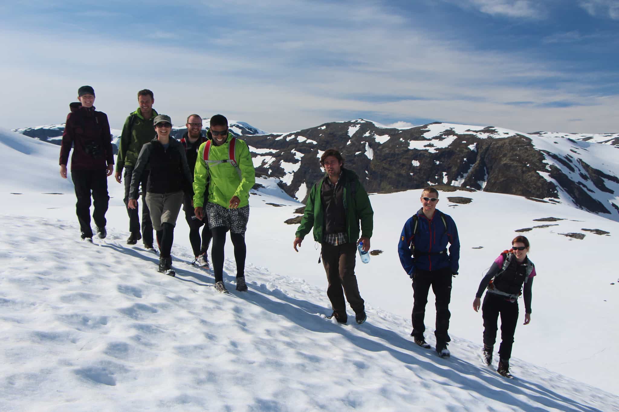 A group of happy hikers in the snow on route to the Breiskrednosi summit in the Norwegian Fords.