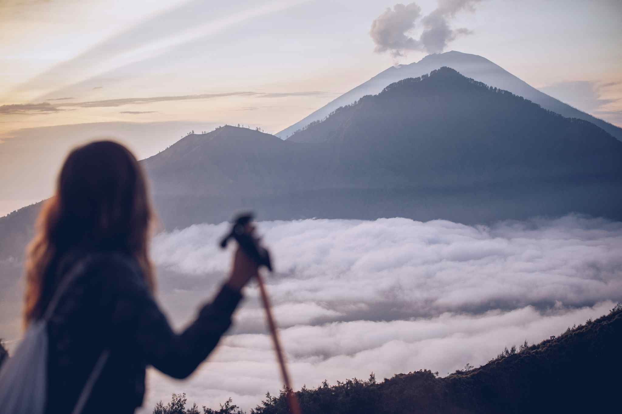 Hiker overlooking volcanoes in Bali, Indonesia