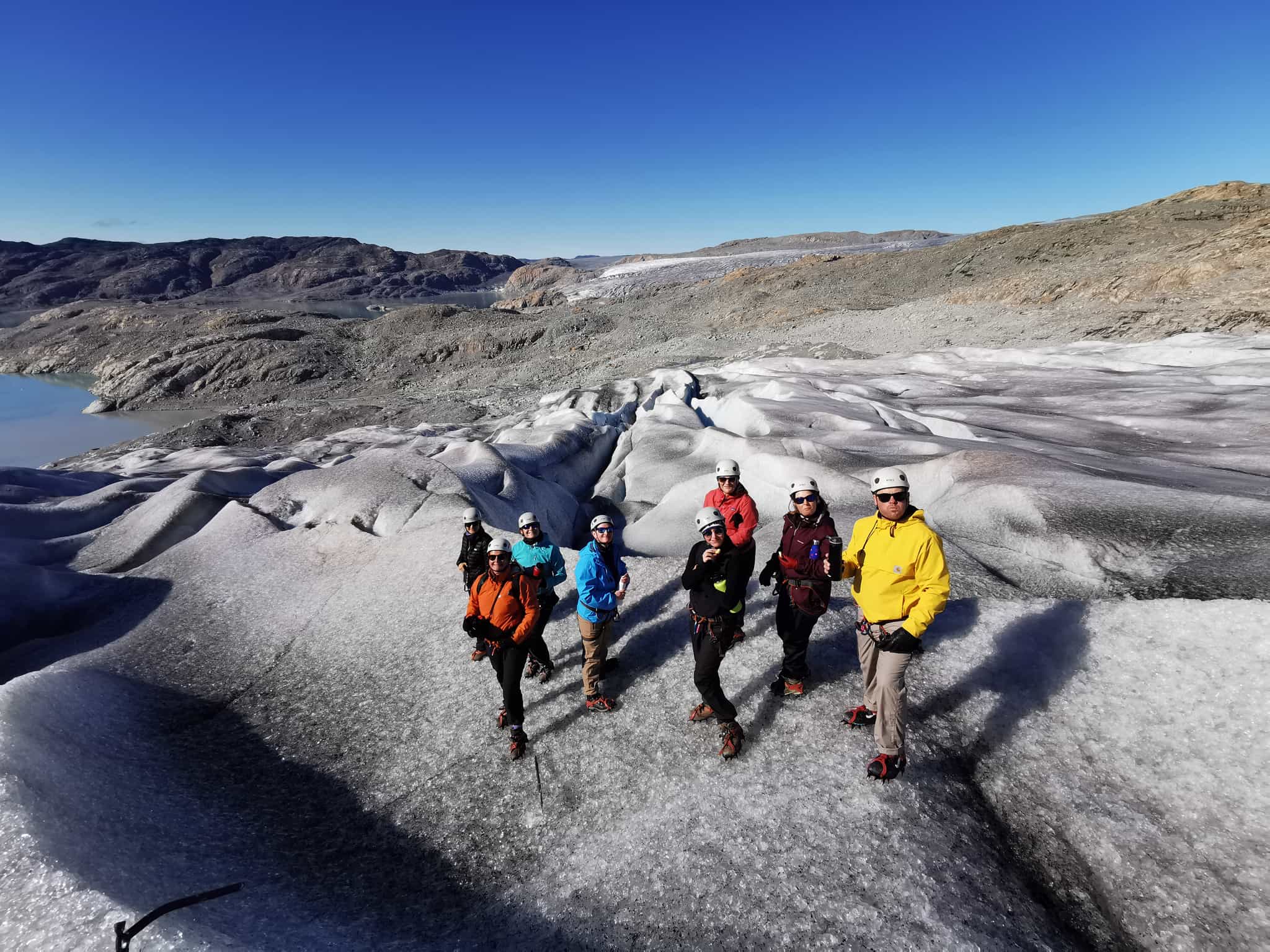 Customers glacier hiking under blue skies near Qaleralig Fjord in Greenland. Photo: Customer/Nicole Morgan.