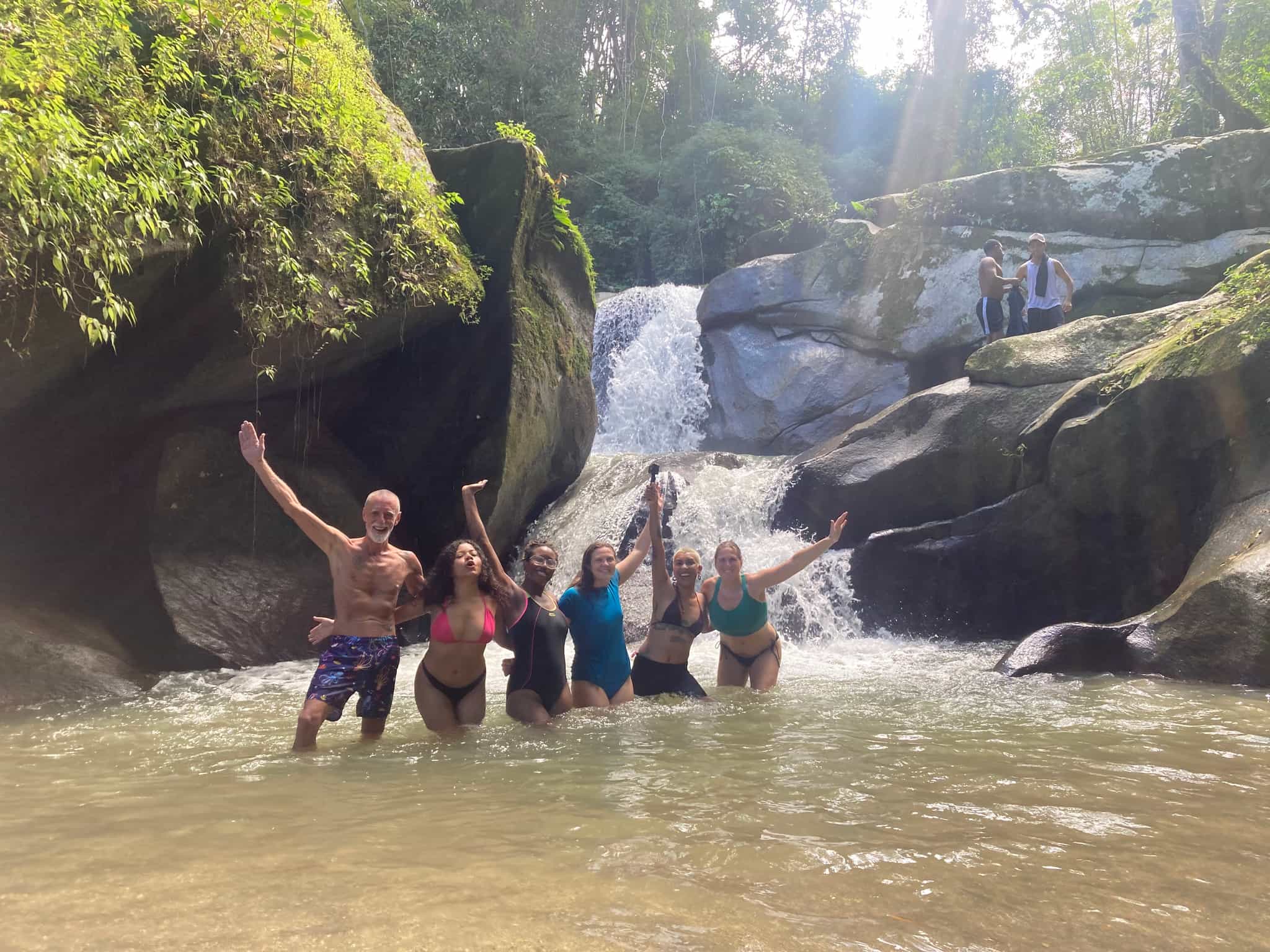 Group of hikers cooling off in a waterfall in Minca, Colombia.