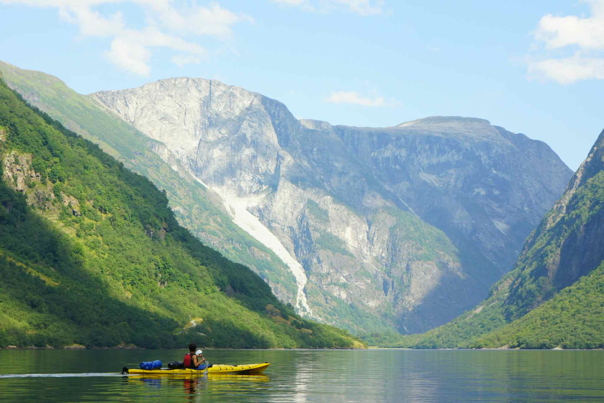 A lone kayaker paddles through the Naeroyfjord in the Norwegian Fjords.
