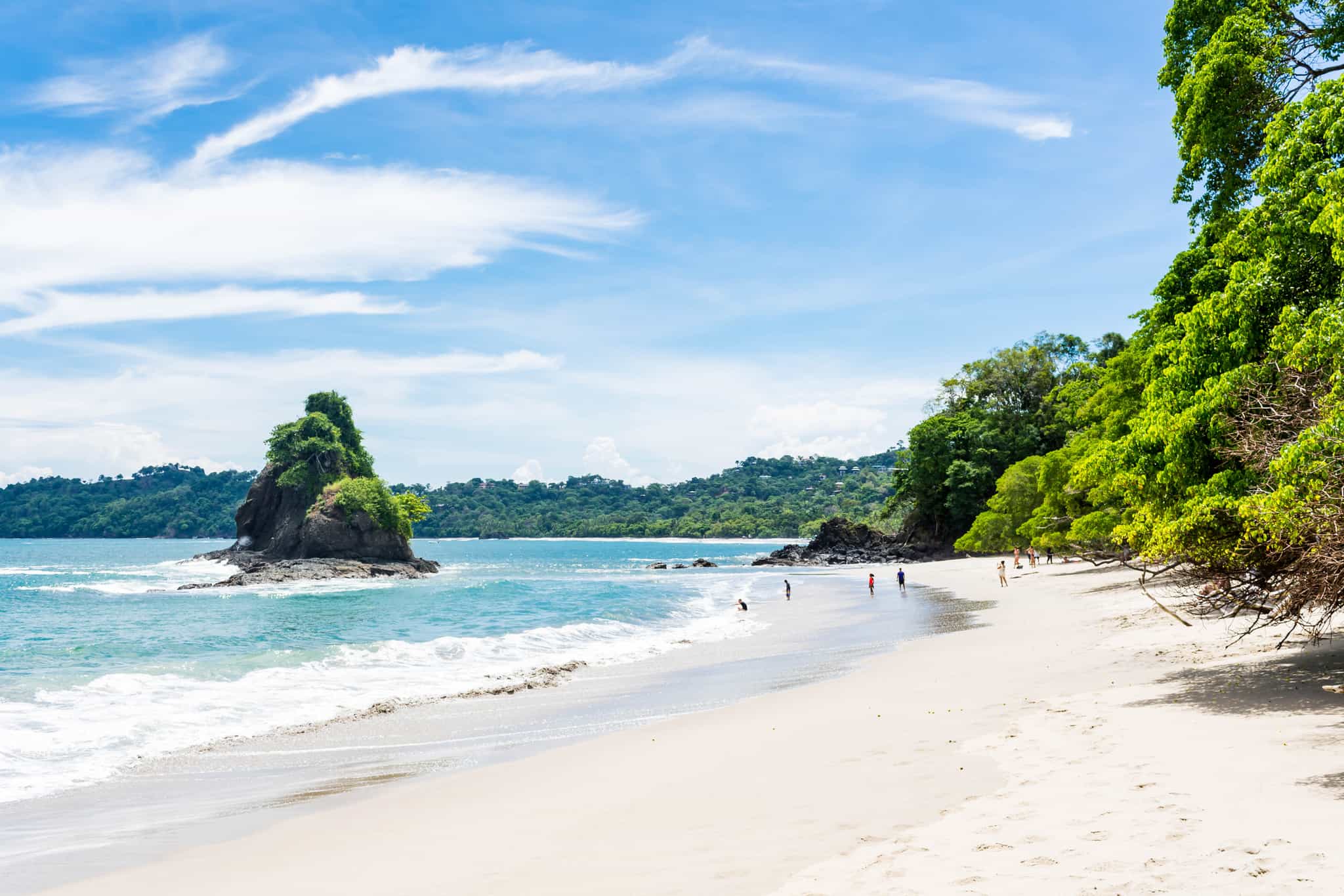 Beach backed by verdant forest in Manuel Antonio, Costa Rica