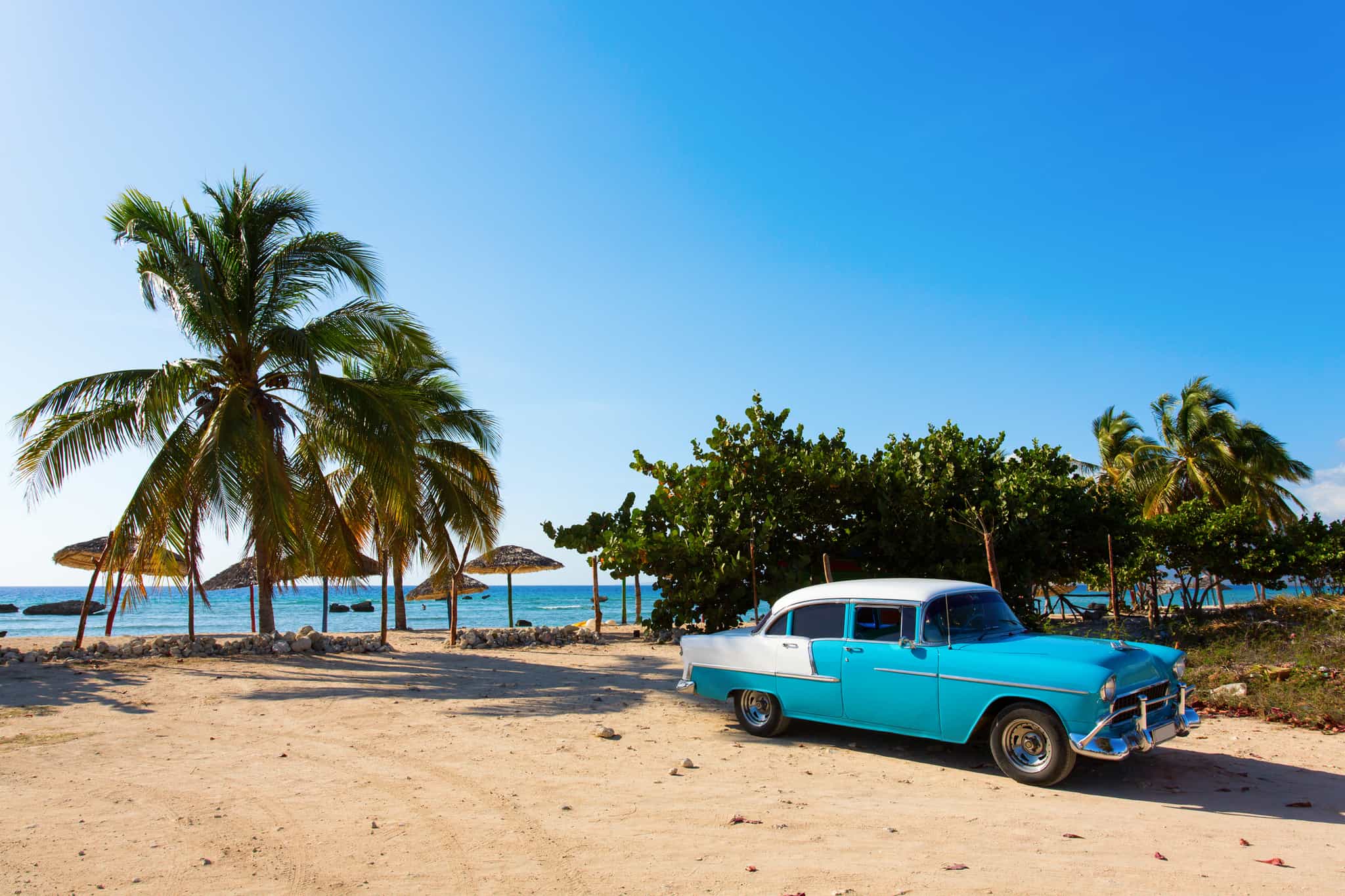 Classic blue car on the beach in Cuba