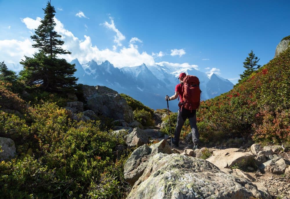 Hiker over looks the Mont Blanc massif on the Tour du Mont Blanc. Photo: Getty