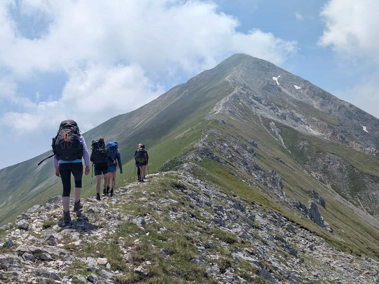 Hikers on a ridgeline trail in the Sharr Mountains.