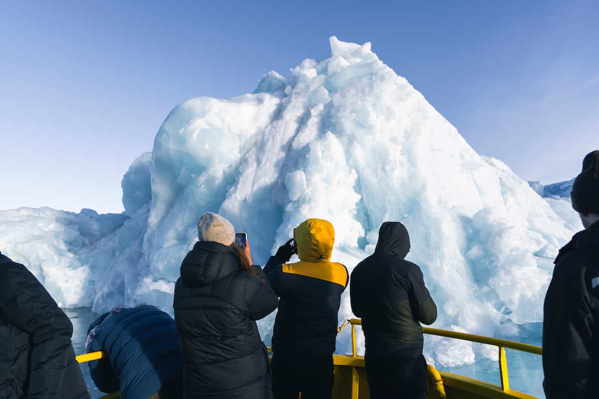 Looking at icebergs from a boat in the Nuuk Icefjord, Greenland.