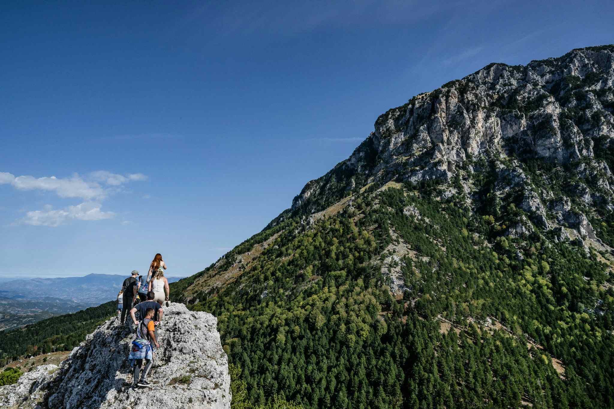 Hikers in the Tomorr Mountains of Albania with blue skies.