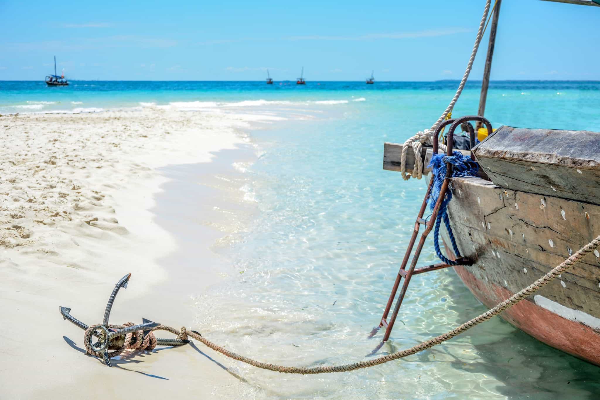 Boat beside an idyllic beach and turquoise waters in Zanzibar.