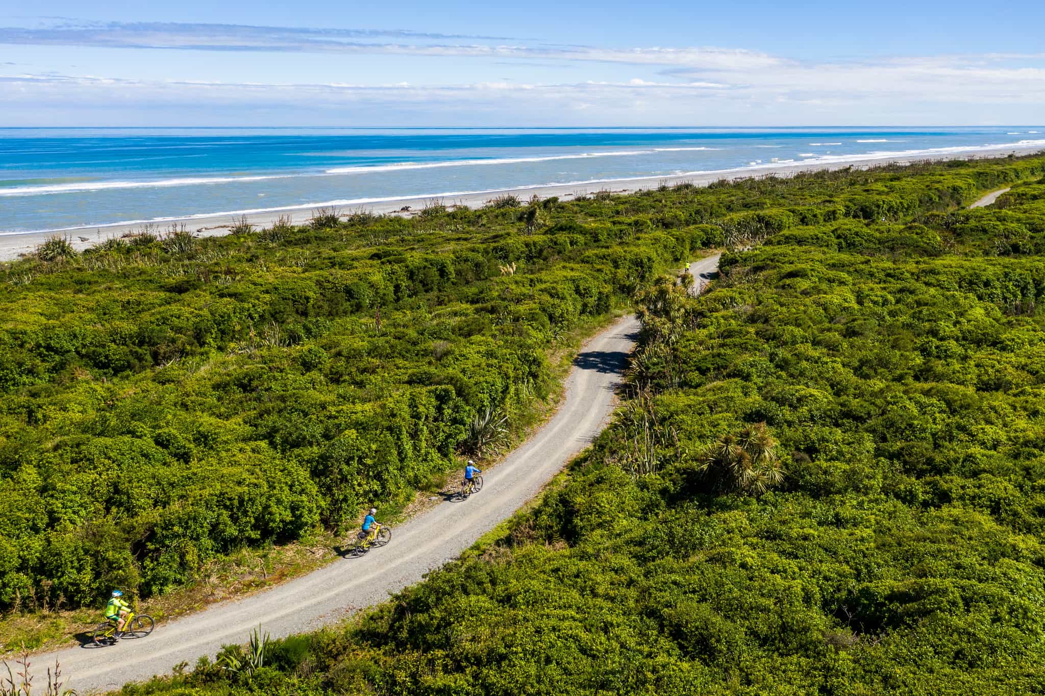 Cyclists on the West Coast Wilderness Trail in New Zealand