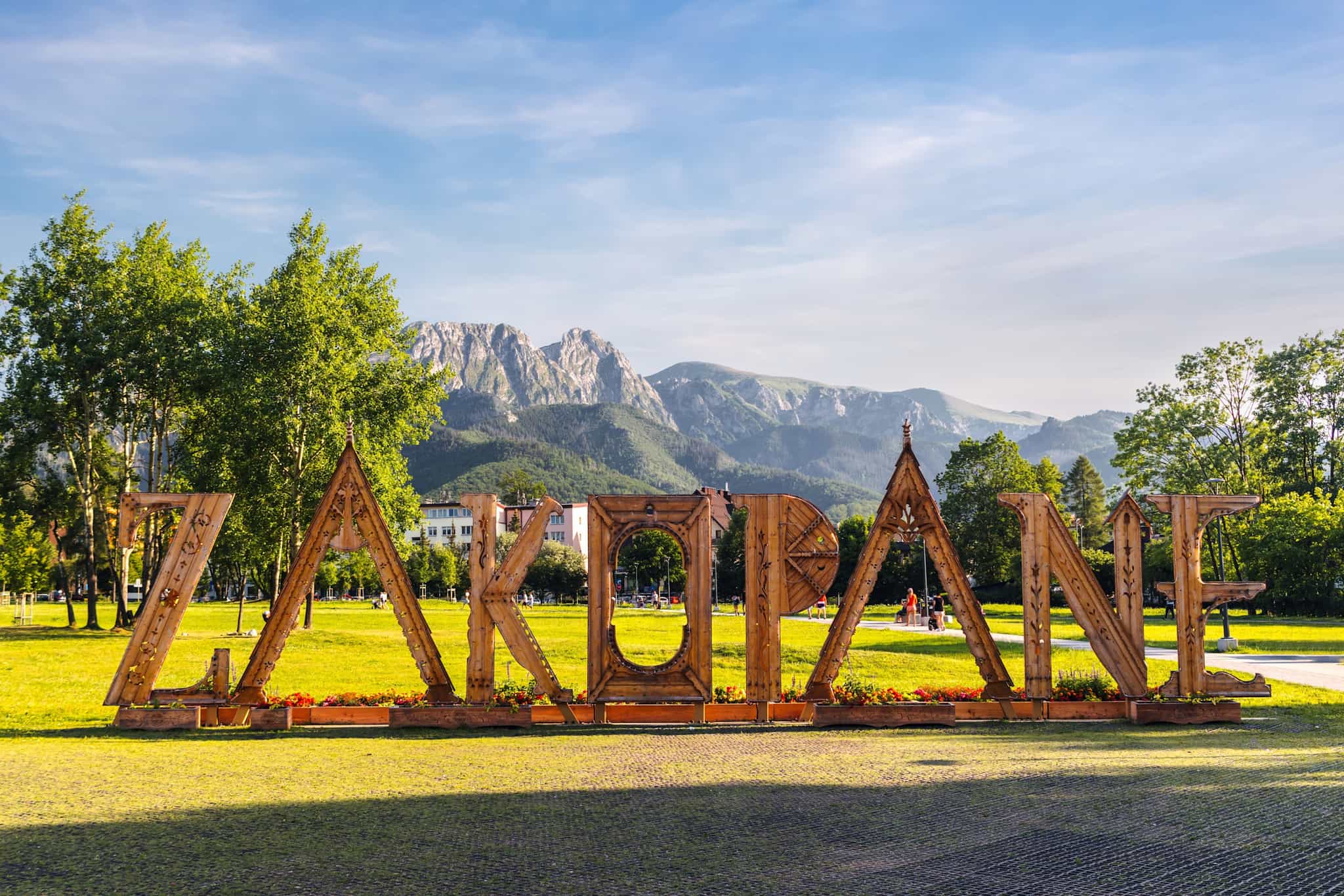 zakopane sign in the town below the mountains
