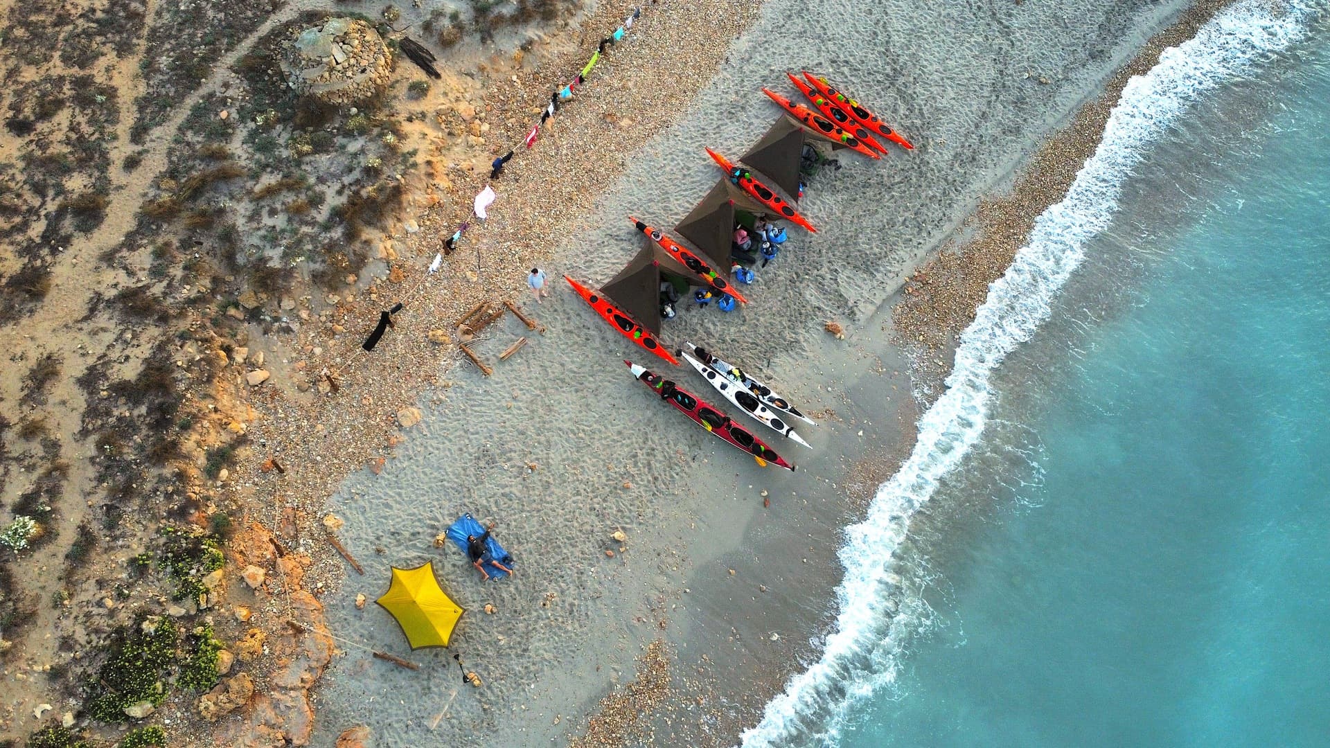 Aerial view of wild camping on the beach in Menorca.