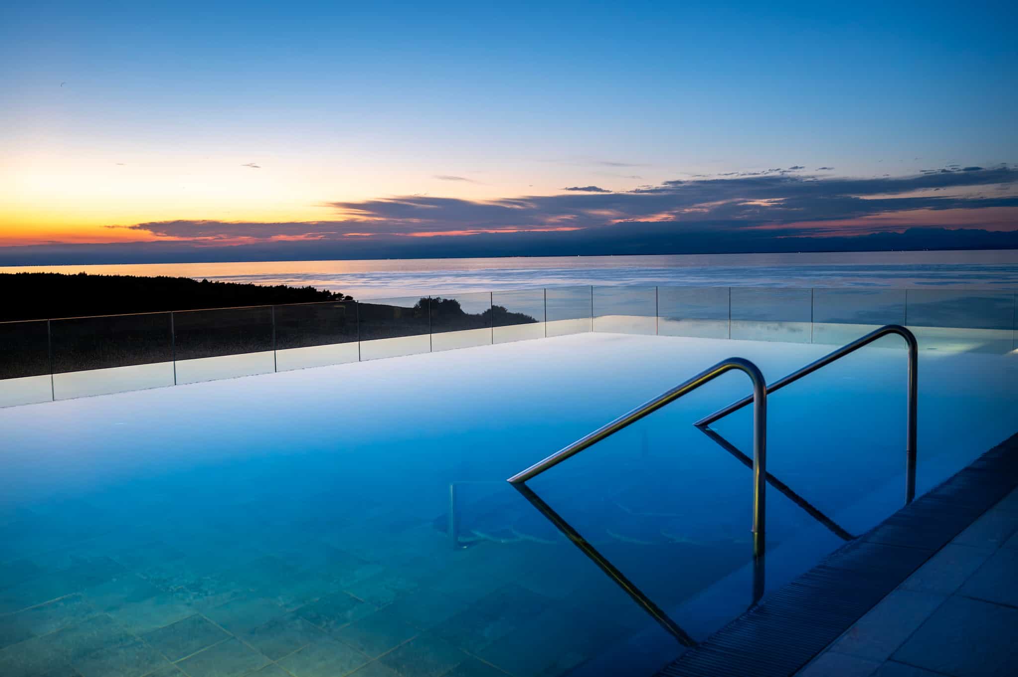 Sunset over the rooftop pool at the Petram Resort