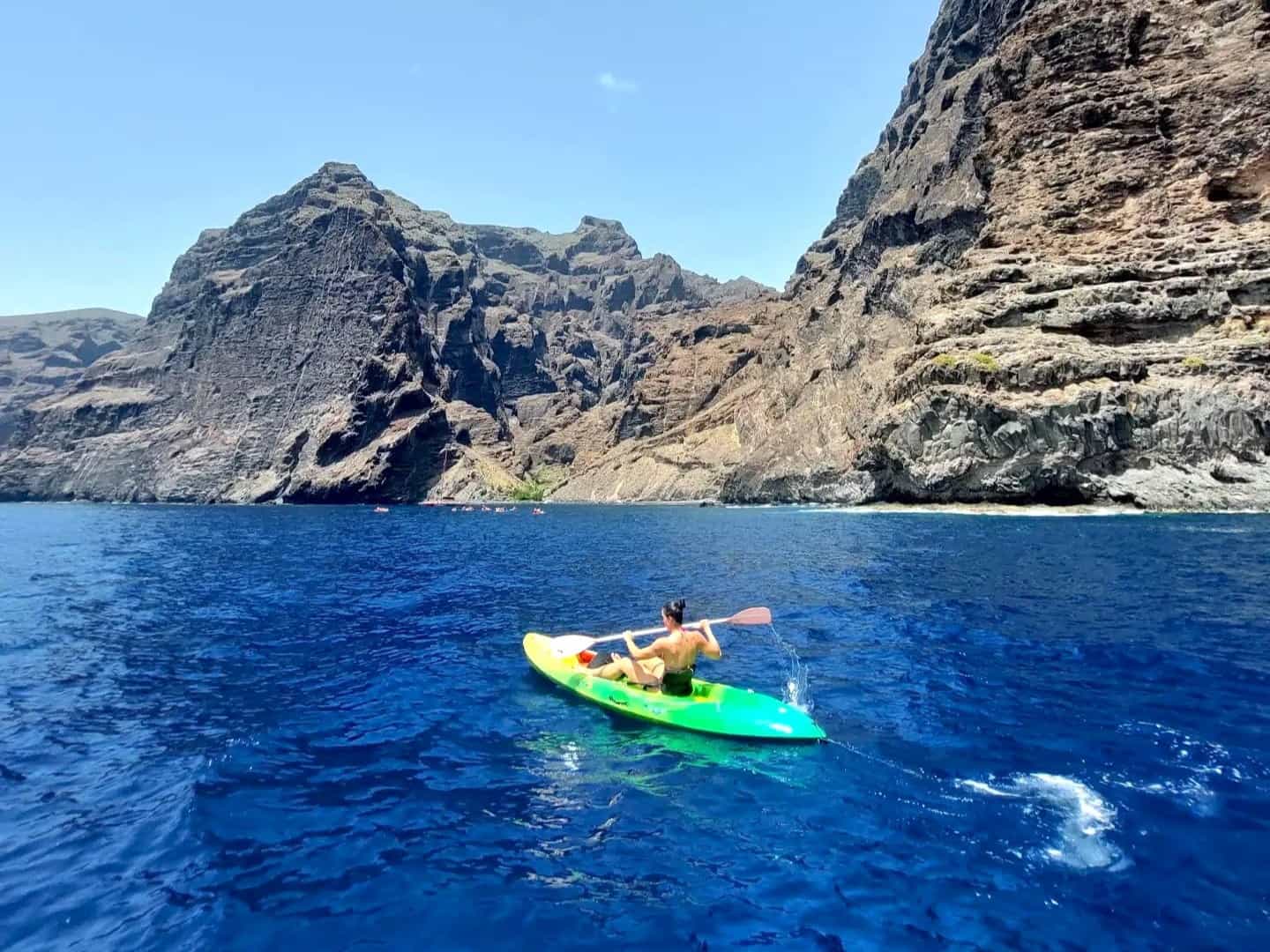 Girl kayaking at the cliffs of Los Gigantes in Tenerife