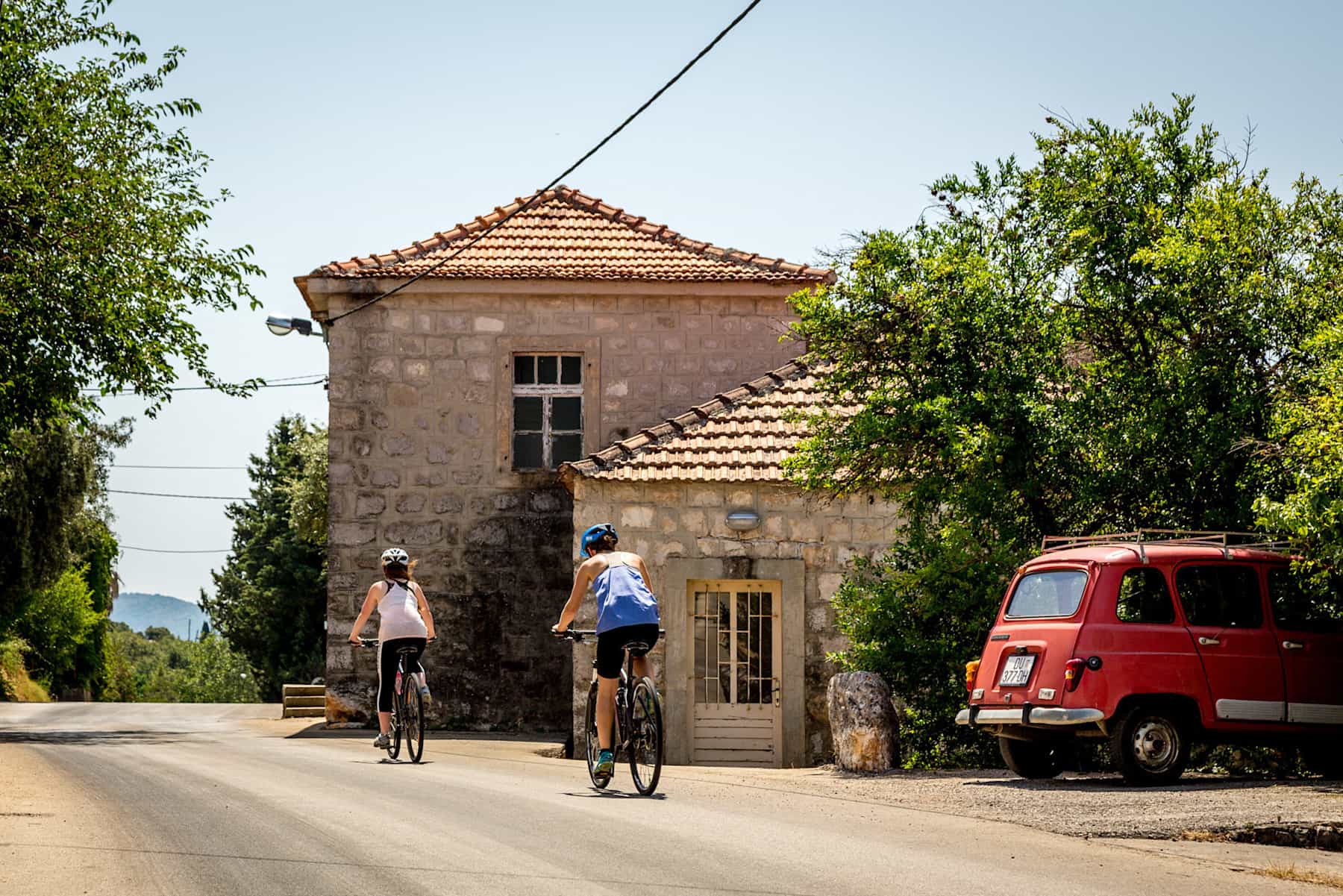 Cycling past historic cars in Bosnia