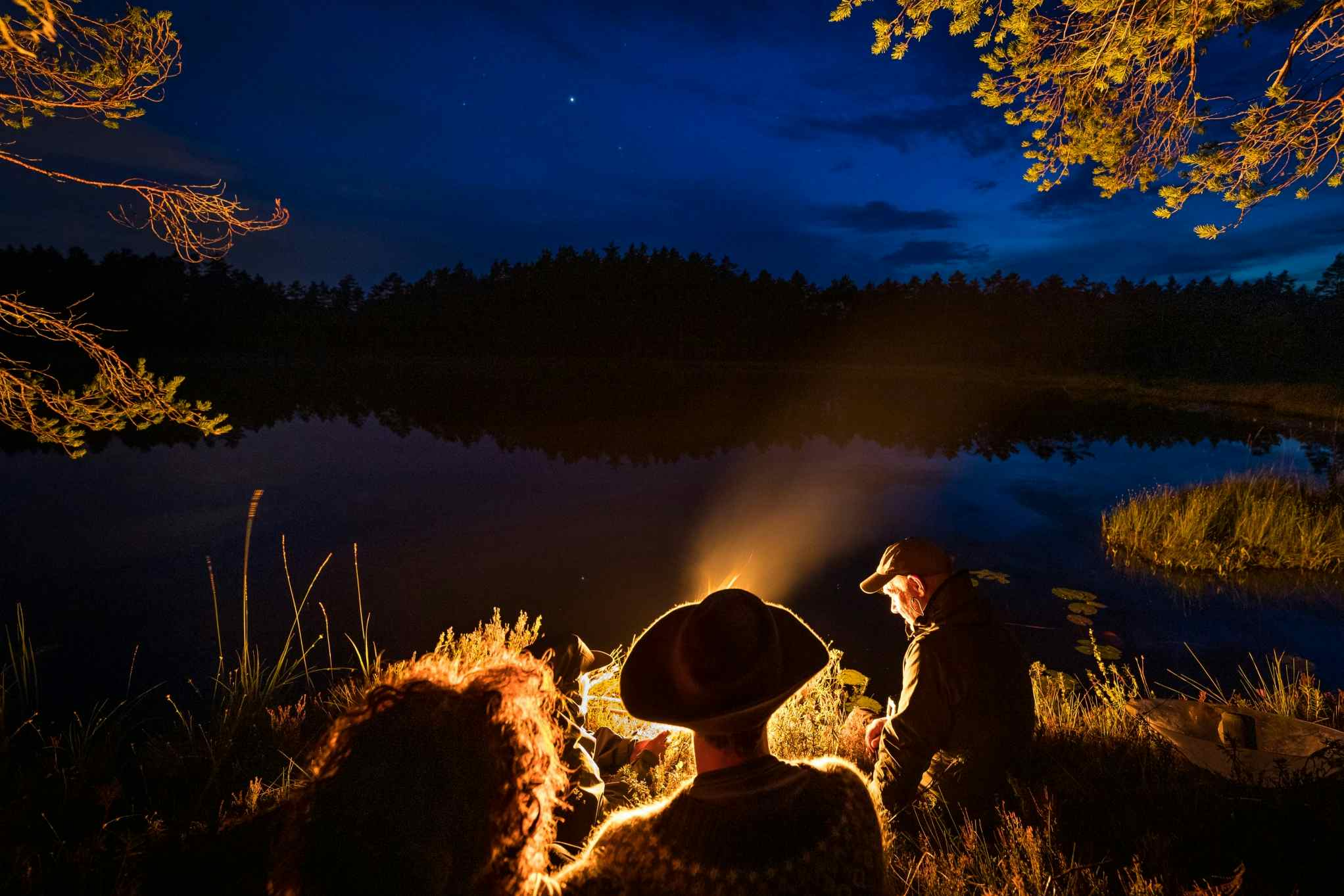 Sitting around the campfire, Sweden. Photo: Marcus Westberg