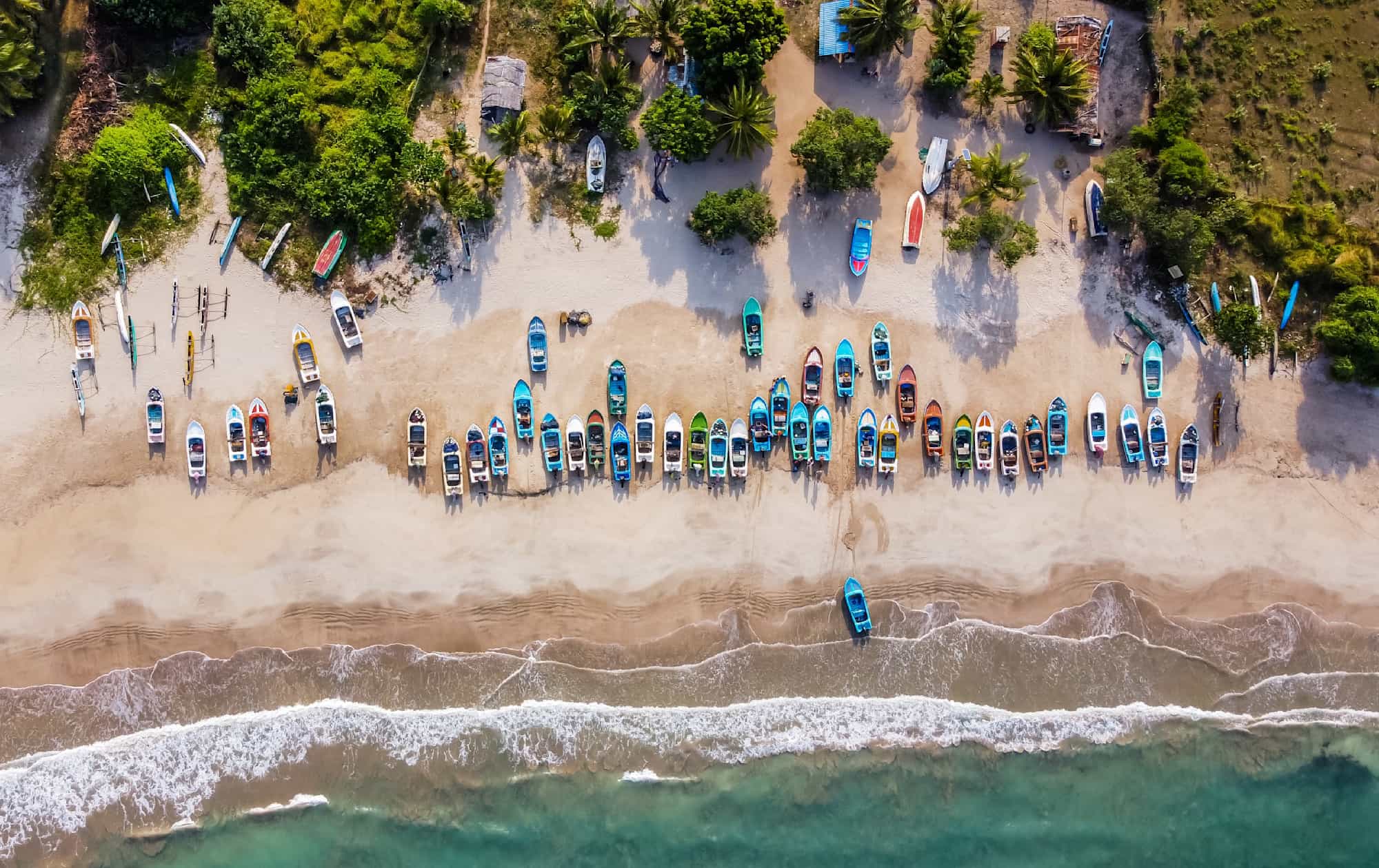 View of the shore line and colourful boats at Pasikuda Beach, Sri Lanka