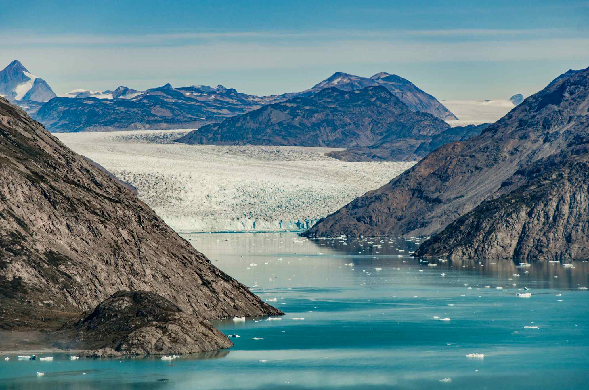 Small icebergs and reflections near a glacier, Greenland. Photo: GettyImages-812610012