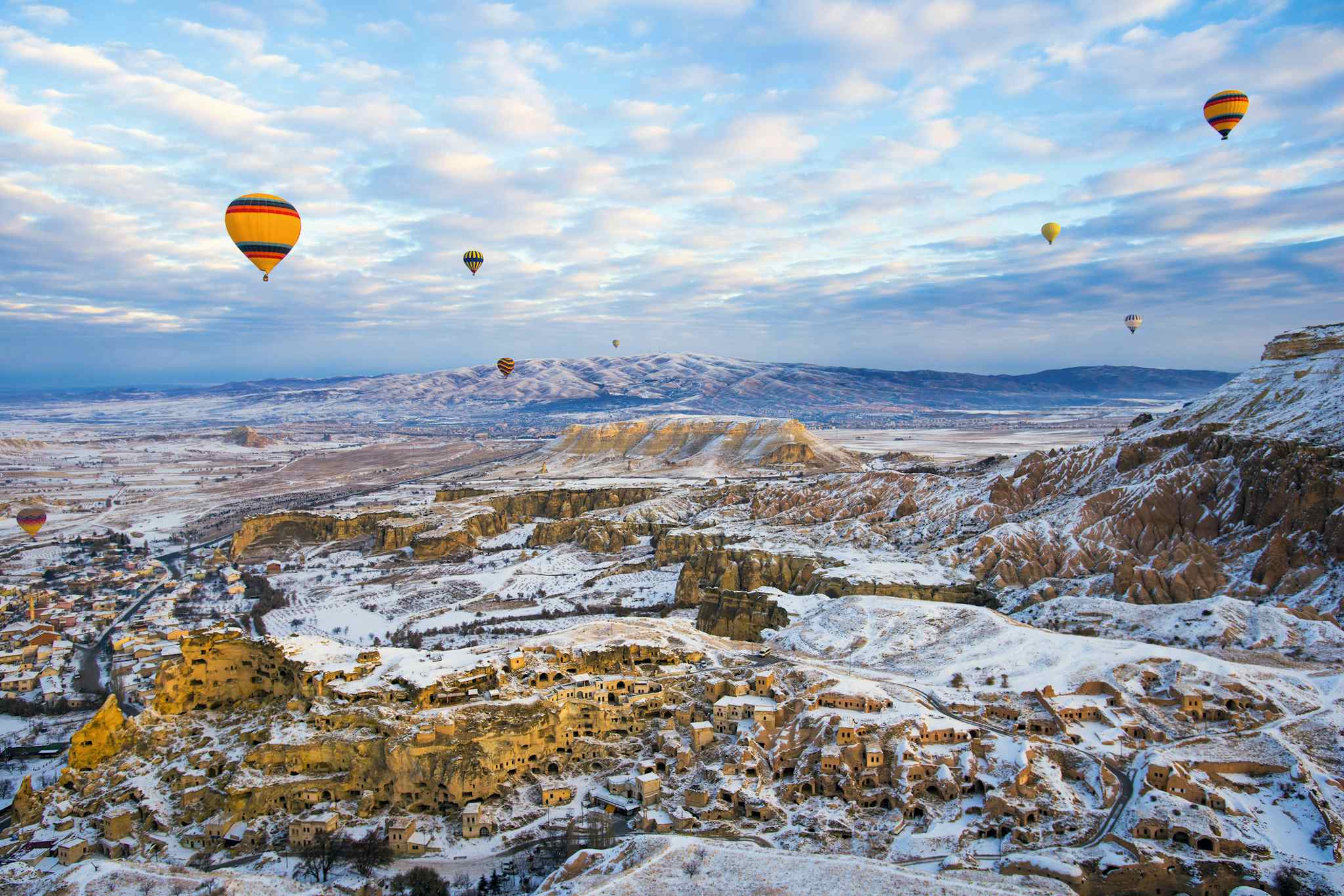 Cappadocia, Turkey, in Winter with Snow and Air Balloon. Photo: GettyImages-1146681685
