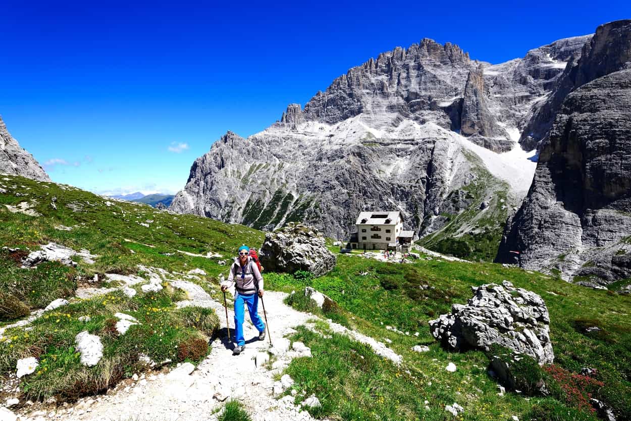 Female hiker in front of the Zsigmondy or Comici hut, Sexten Dolomites, Alta Pusteria, South Tyrol, Italy