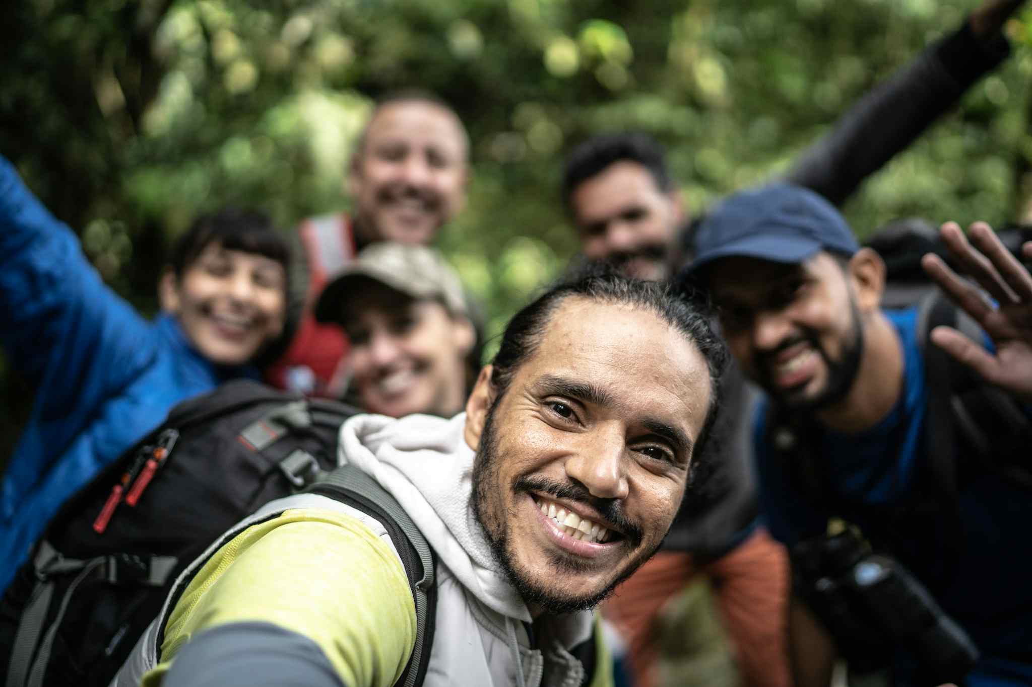 A group of smiling Camino de Costa Rica hikers in the forest, Costa Rica.