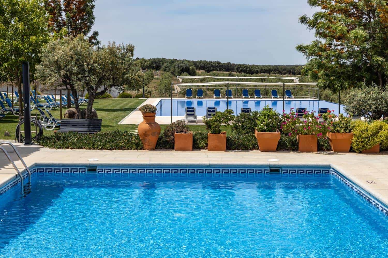 Vila-Planicie hotel in Monsaraz, overlooking the pools and lush greenery.