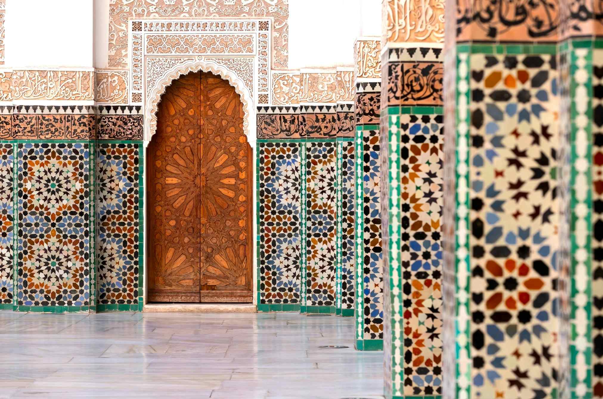 Typical moroccan tiles in the madrasa, Morocco. Photo: GettyImages-1473696412