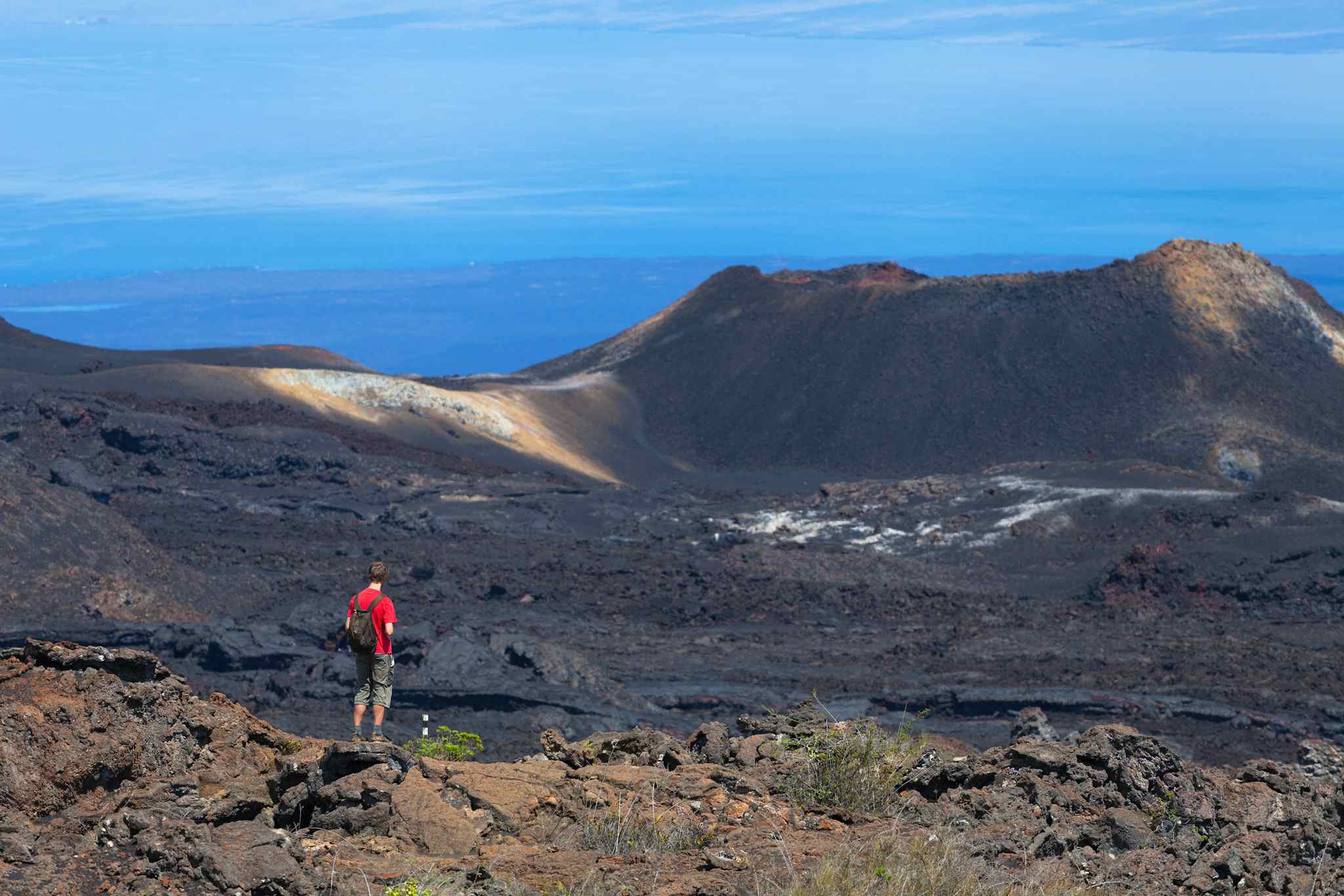 A male hiker on the trails of the Sierra Negra Volcano in the Galapagos Islands. 