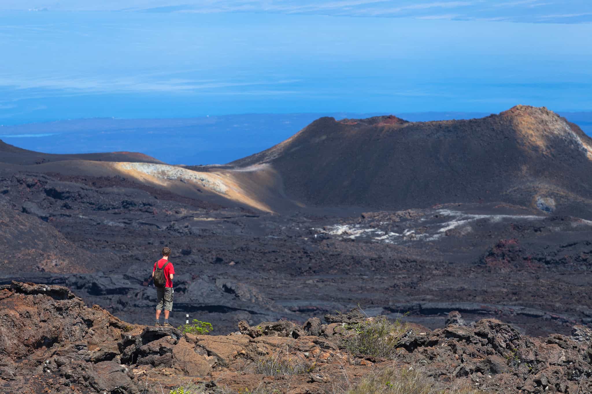 A male hiker on the trails of the Sierra Negra Volcano in the Galapagos Islands. 