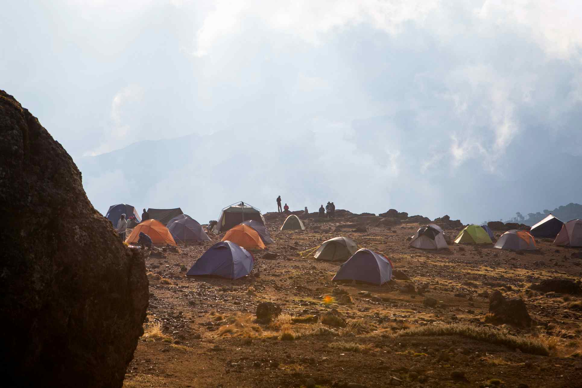 Tents pitched at Shira Camp with a cloudy backdrop on Mount Kilimanjaro, Tanzania.