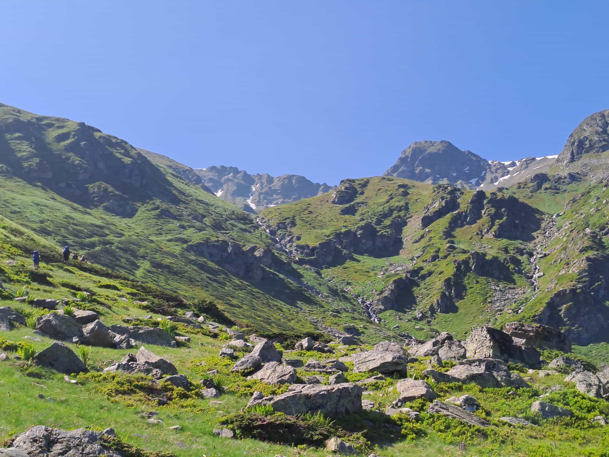 Hikers in the green landscapes of the Sharr Mountains.