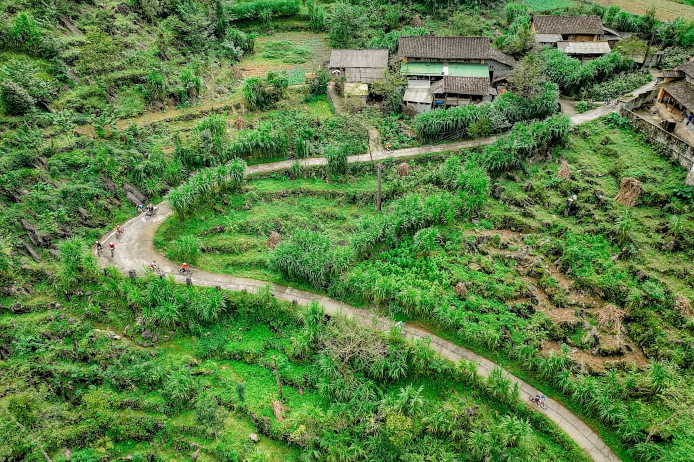 Aerial view of cyclists on a road in Ha Giang, Vietnam