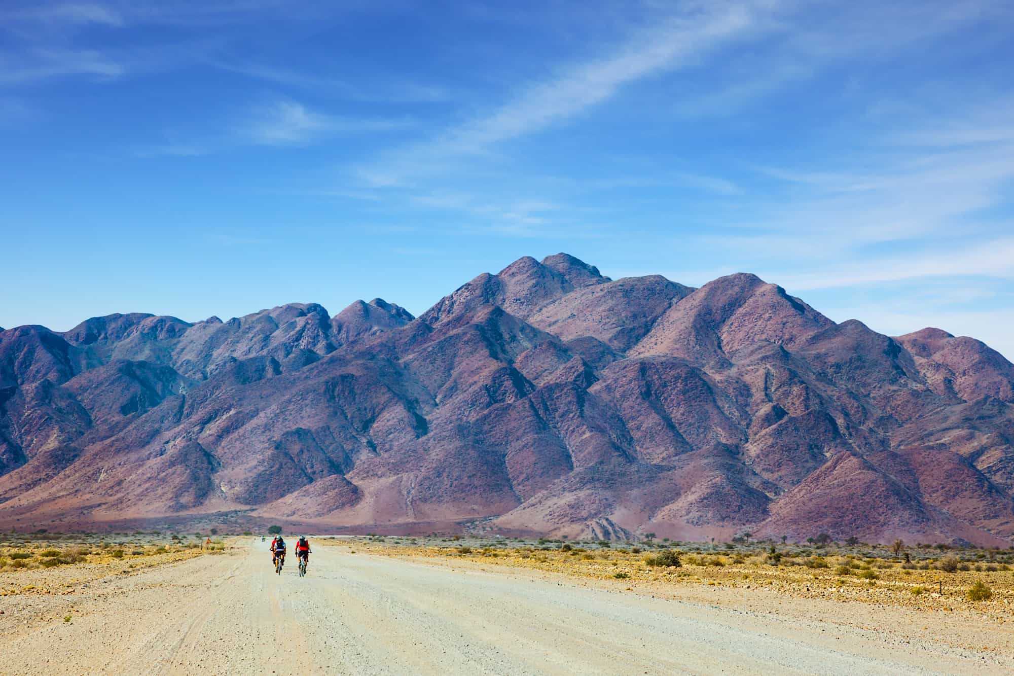 Two cyclists riding through the desert landscape of Namibia