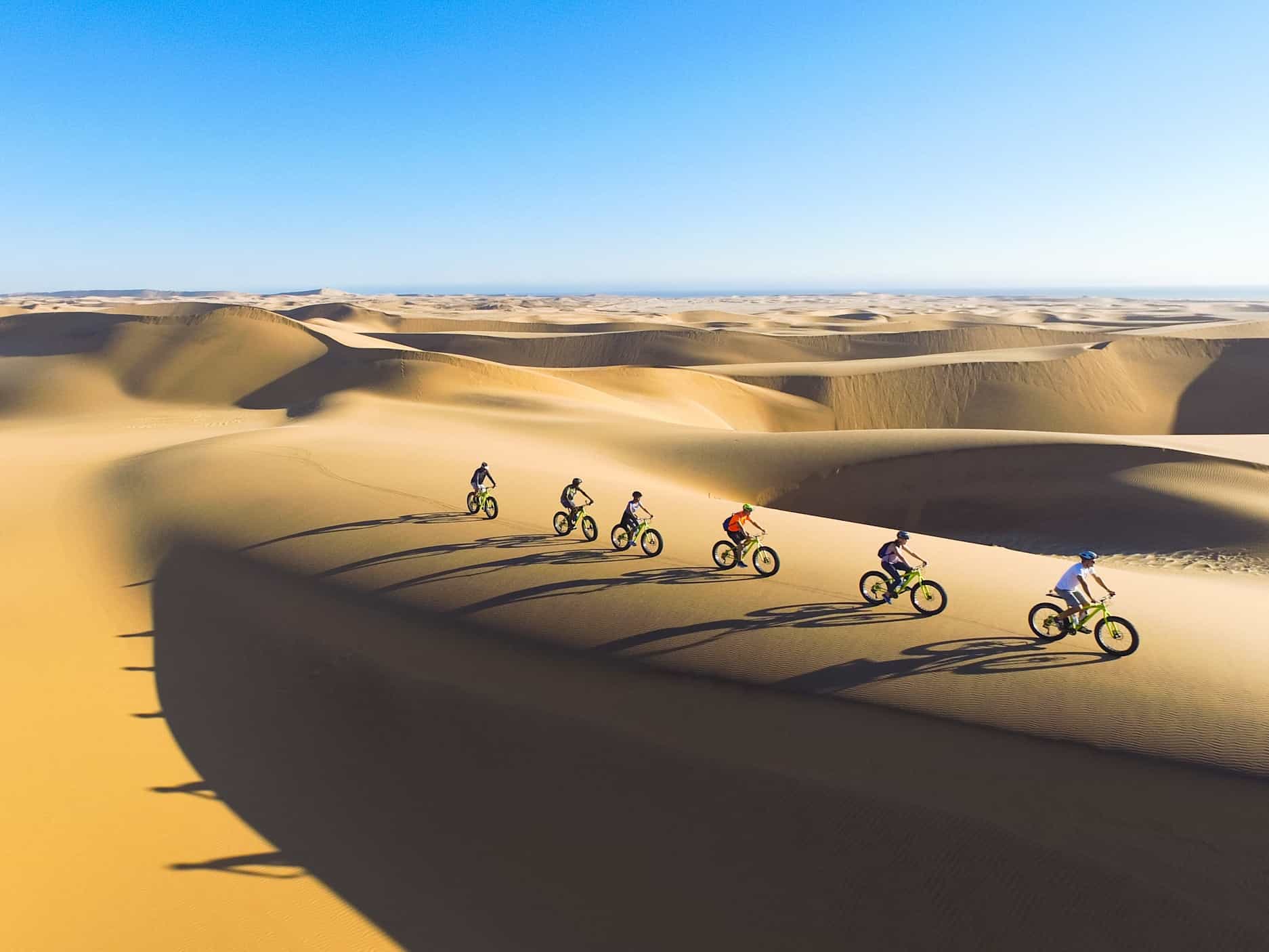 People on fat bikes riding the dunes in Namibia.