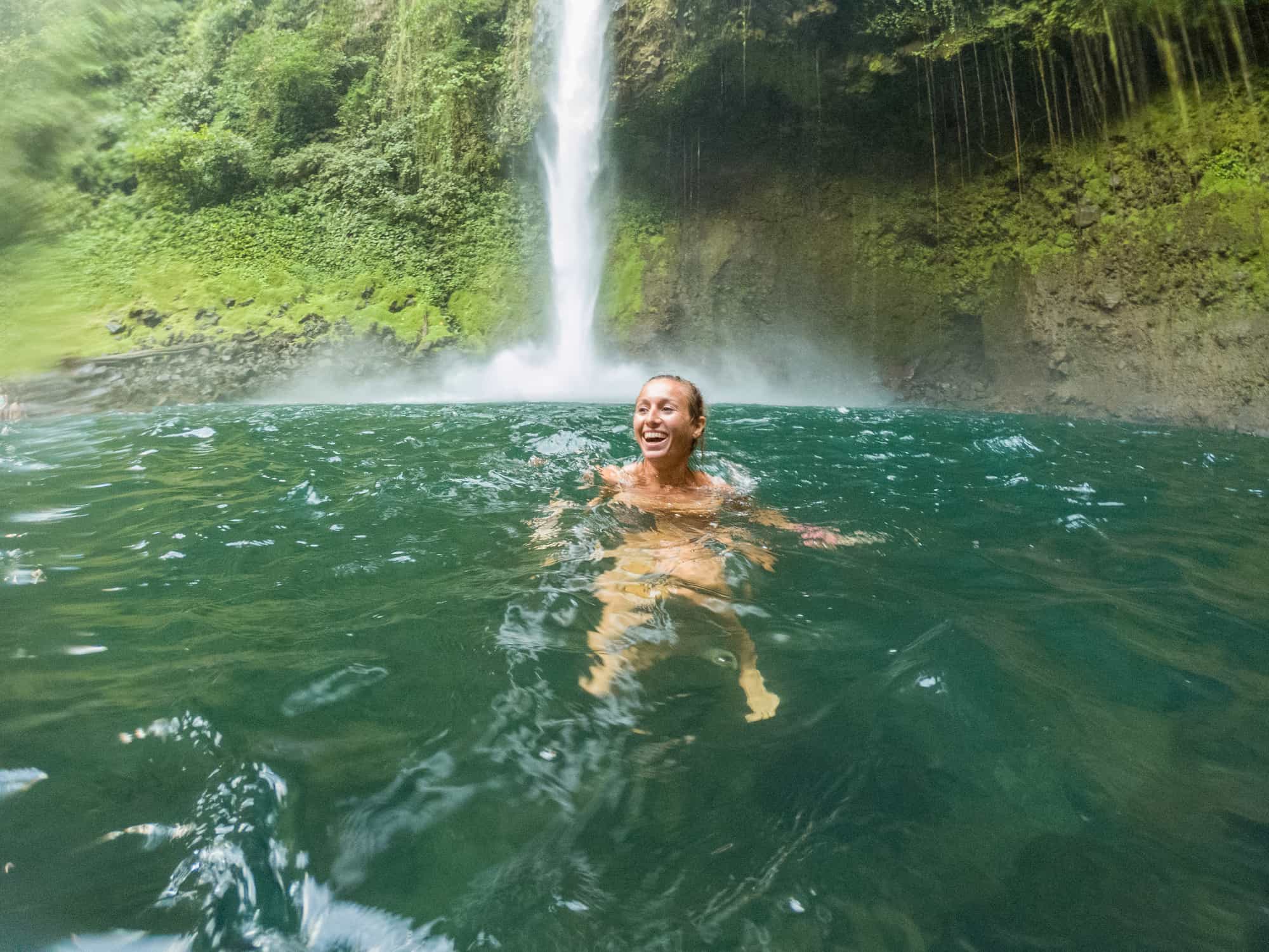 Swimmer in a waterfall, Costa Rica. Photo: iStock-1199455834