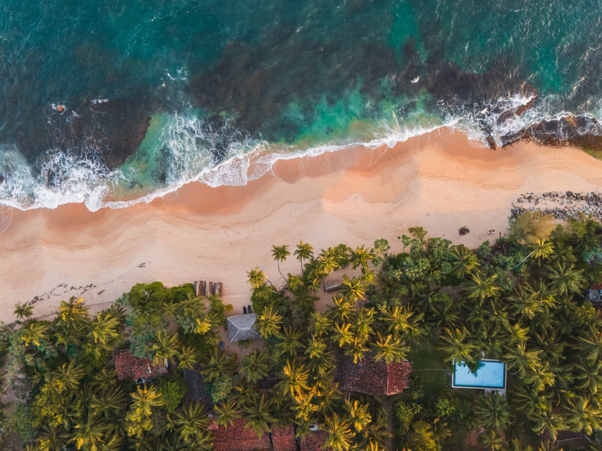 Scenic aerial view of idyllic sandy beach on Sri Lanka at sunset.