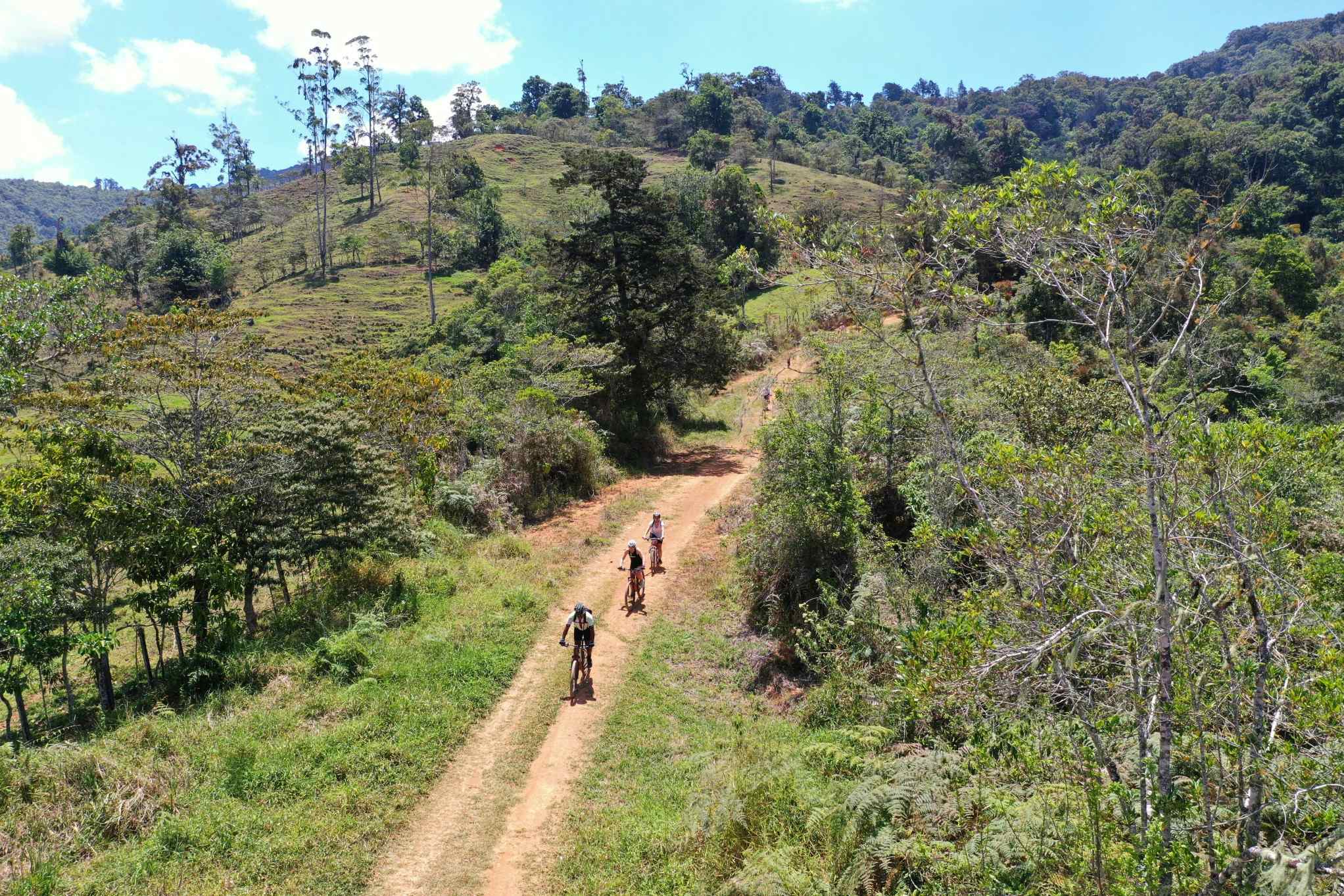 Cyclists pedalling along a track in Costa Rica