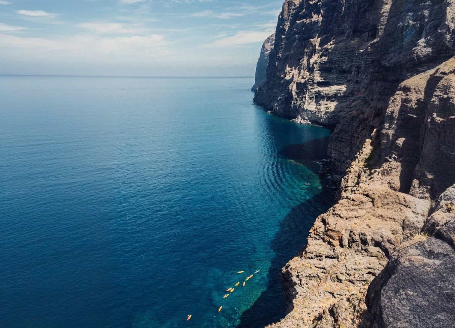 People kayaking along the cliffs of Los Gigantes in Tenerife.