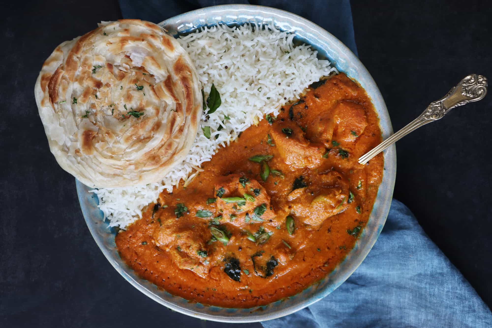 Indian curry with rice and paratha bread