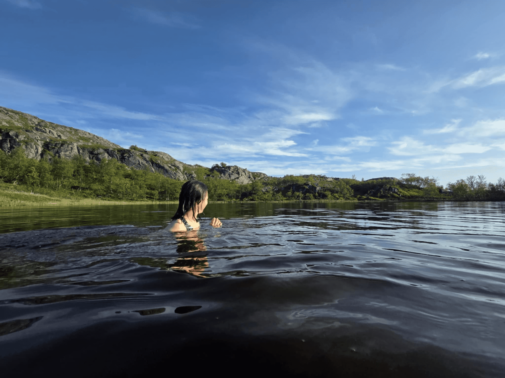 Wild swimming in summer in Alta, Norway.