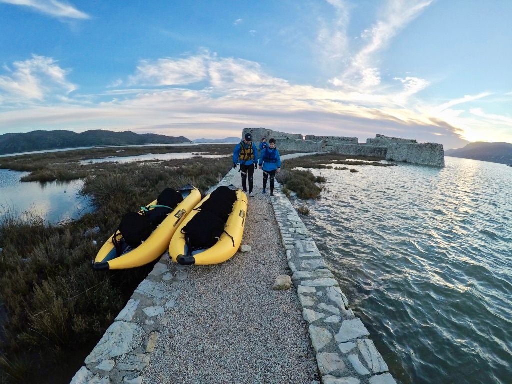 Inflatable kayaks pulled up onto the walkway leading to Ali Pasha Castle in Albania