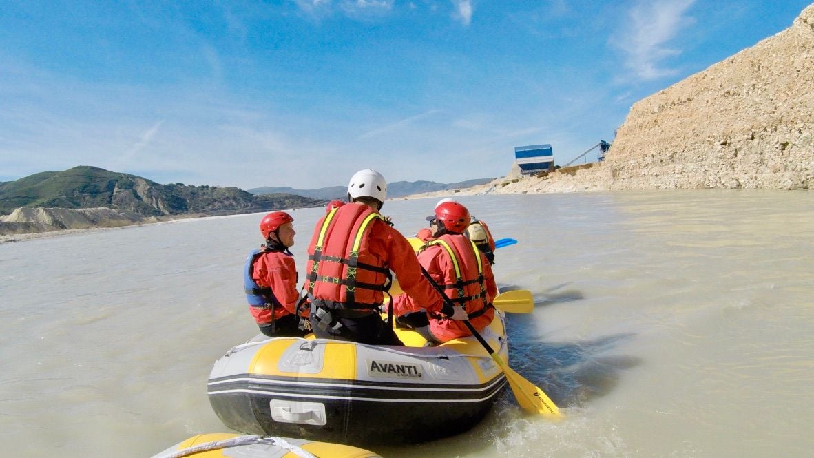 A rafting group pass the construction works for a dam site in the Vjosa, Albania