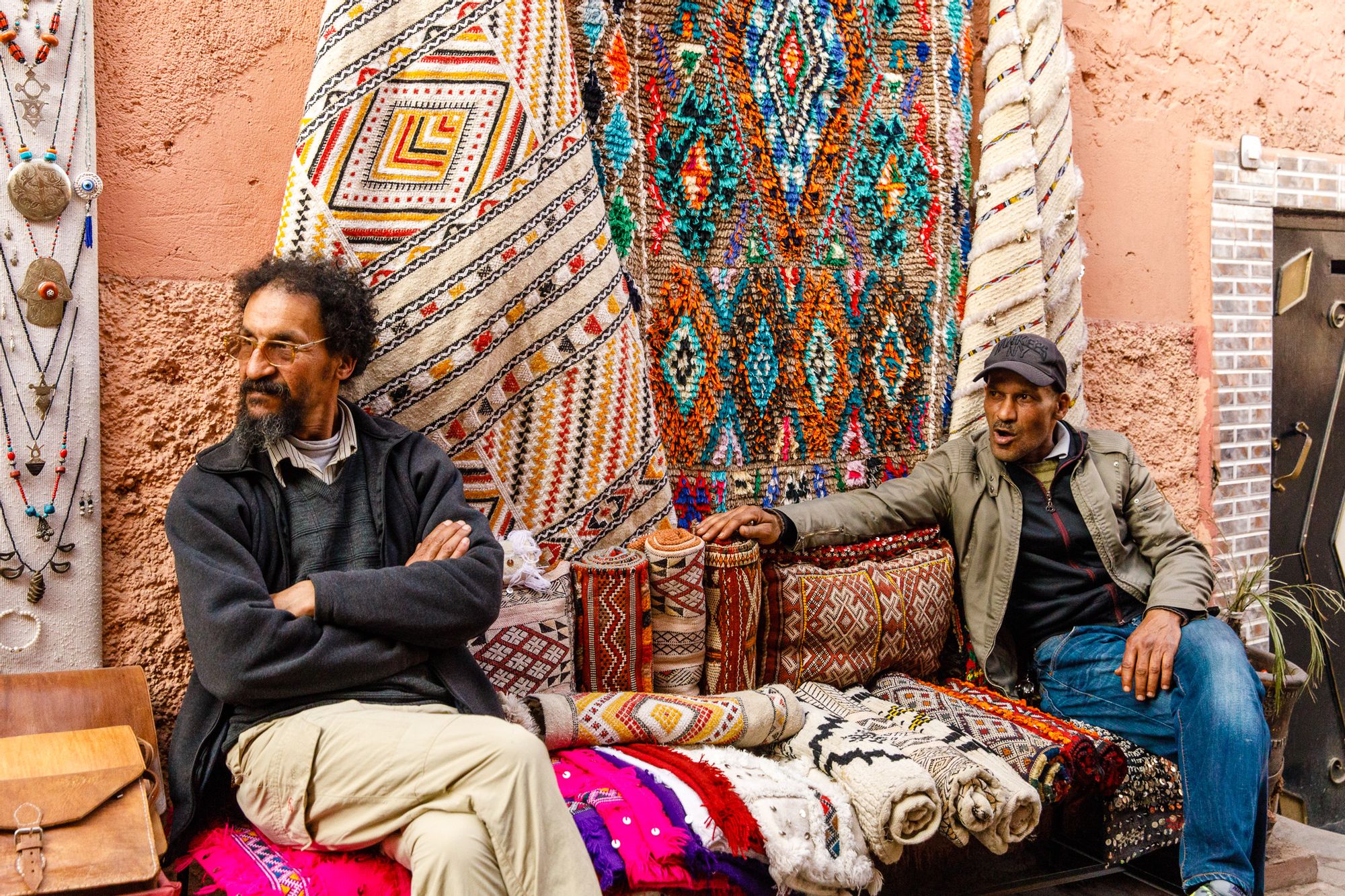 Two men selling Kilim rugs on an Imlil street, Morocco