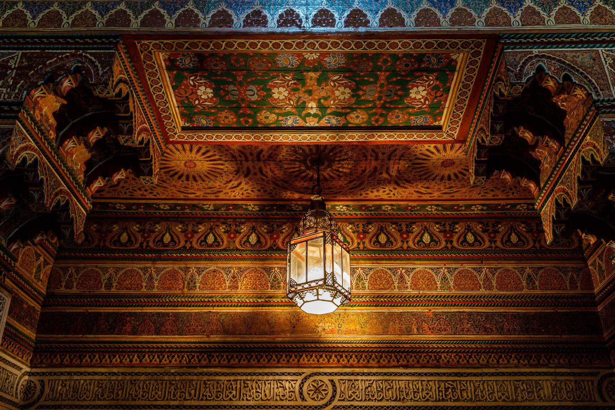 Imlil, Morocco A Moroccan lamp reflects light on an ornately painted ceiling in Imlil, Morocco.